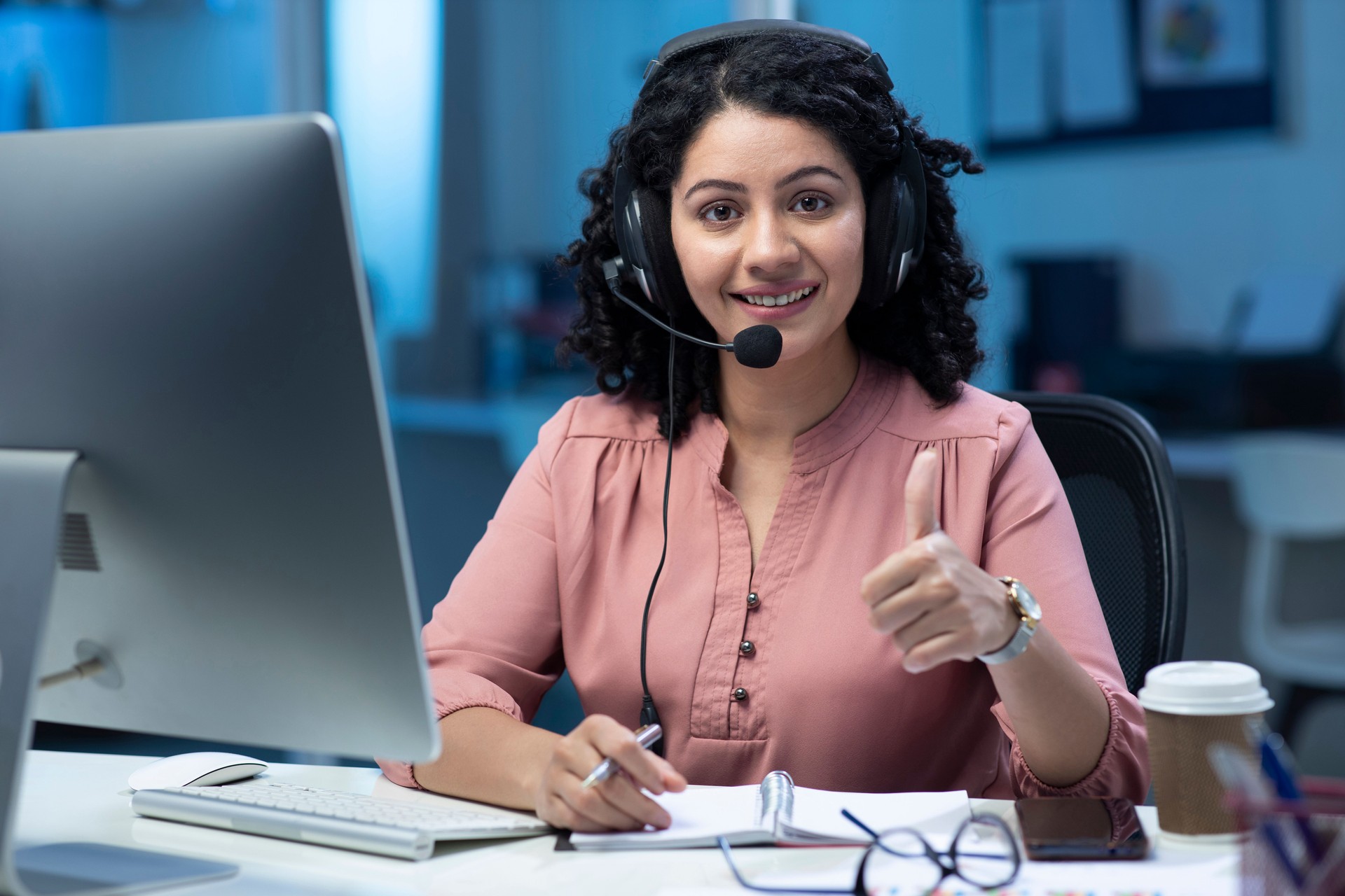 shot of a young female call center agent working in office:- stock photo