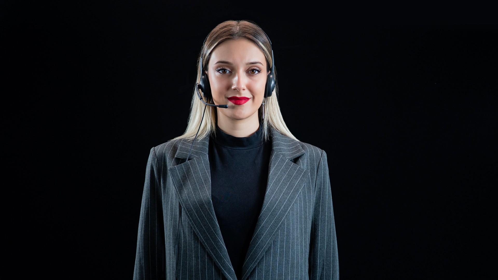 Confident young female customer service agent with headset.